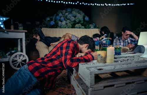 Fotografering Young drunk and tired friends sleeping after outdoors party