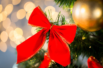 close up of red bow decoration on christmas tree