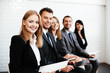 © baranq - Group of happy business people sitting in a row