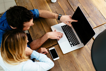 Wall Mural - Mockup of young couple with laptop at cafe