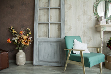 Wall Mural - Interior retro room with an armchair, flowers, door and mirror