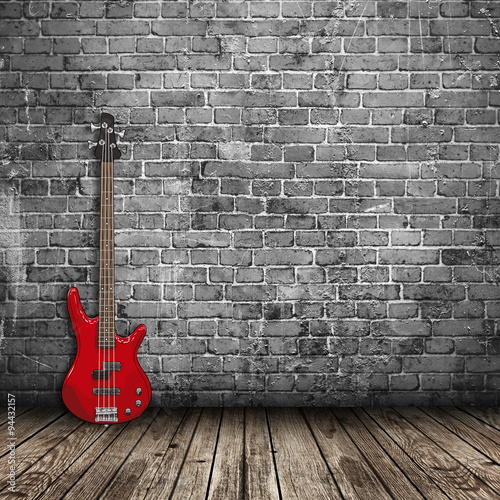 Naklejka - mata magnetyczna na lodówkę Elektryczna czerwona gitara na tle kamiennej ściany