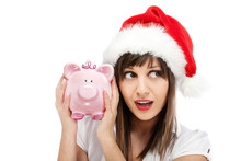 Young Woman With Santa Cap Holding Piggy Bank