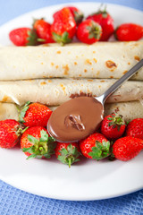 Wall Mural - Pancakes with chocolate and strawberries