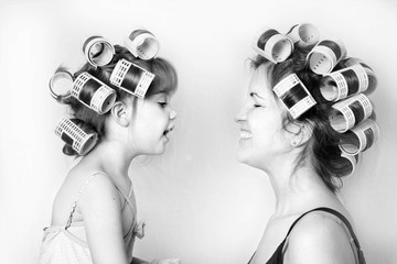 vintage image of a mother and daughter wearing rollers in their hair and having a good time