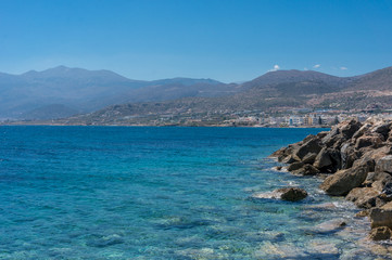 Wall Mural - stones in a sea and blue sky water 