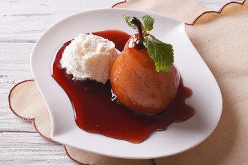 Beautiful food: poached pear in syrup and vanilla ice cream close-up 
