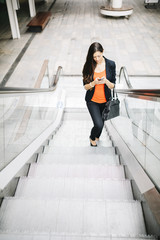 Portrait of a beautiful young businesswoman standing outside usi