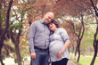 © hreniuca - Happy and young pregnant couple embracing in nature