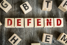 Wooden Blocks With The Text: Defend