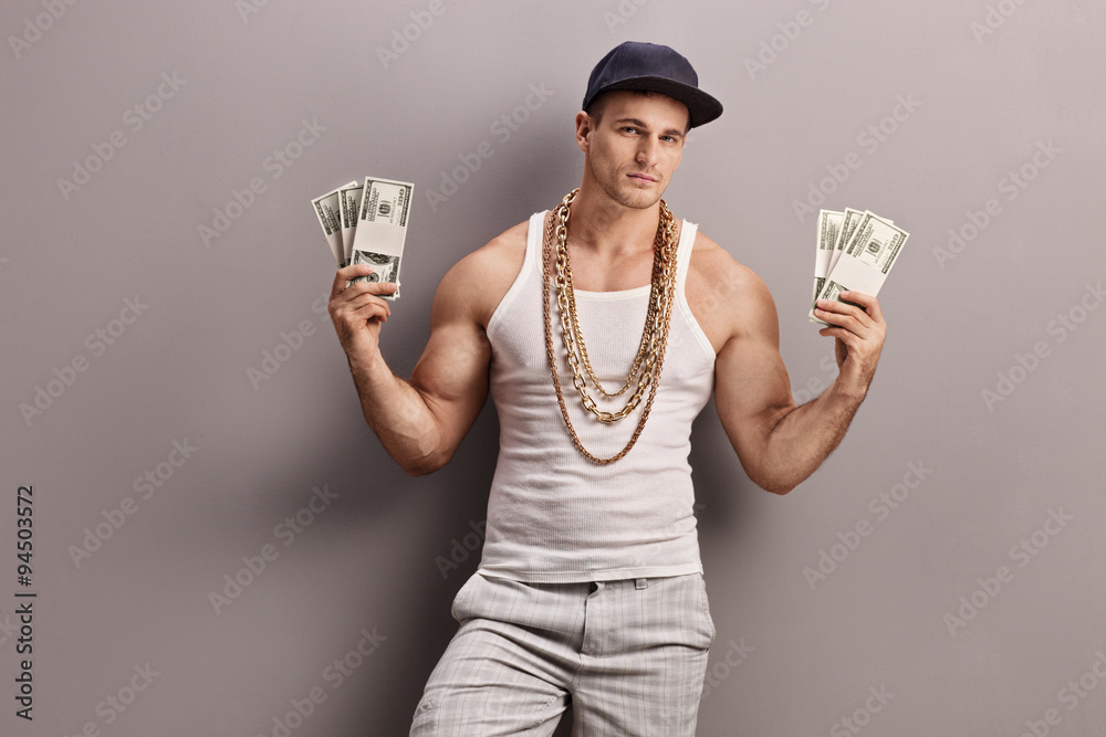 Young male rapper holding money - obrazy, fototapety, plakaty 