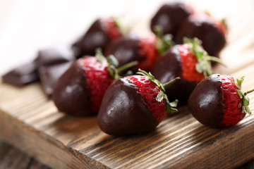 Poster - Fresh strawberries dipped in dark chocolate on grey wooden backg