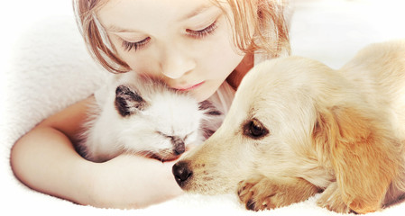 little cute girl affectionately hugging  kitten and Puppy