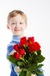 © OlgaKhorkova - Little boy giving bouquet of red roses
