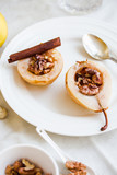 Fototapeta  - spicy baked pear with walnuts, honey, healthy dessert,selective