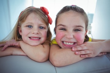 Wall Mural - Happy kids looking from the back of the couch