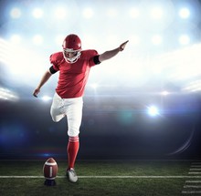 Composite Image Of American Football Player Kicking Football
