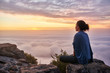 Leinwandbild Motiv Woman on a mountain top looking at morning clouds