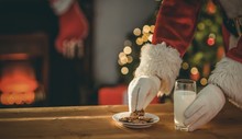Santa Claus Picking Cookie And Glass Of Milk