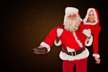 Composite Image Of Santa And Mrs Claus Smiling At Camera 