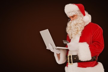 Poster - Composite image of santa claus shopping online with laptop 