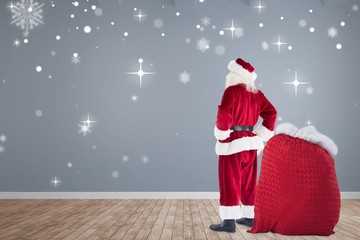 Poster - Composite image of happy santa with sack of gifts