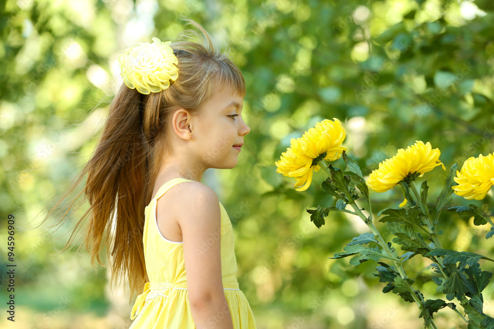 Little girl with flowers outside