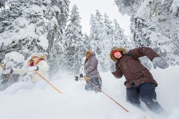 Wall Mural - Young adults snowshoeing