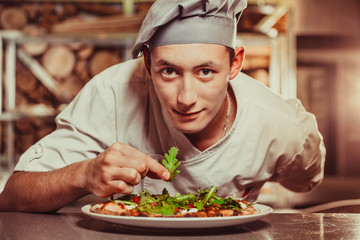 male cook preparing delicious appetizer