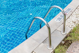 Fototapeta  - The metallic ladder for using entrance to swimming pool.