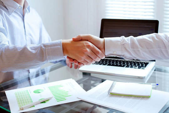 business meeting, handshake close up in office background