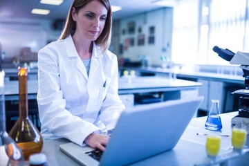 Scientist working with a laptop in laboratory