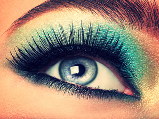 Wall Mural - Woman's eye with green eye make-up. Long eyelashes