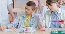 Schoolchildren And Teacher In Science Class