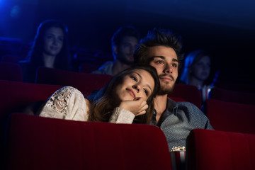 Wall Mural - Young loving couple at the cinema