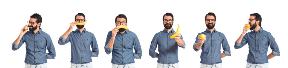 Wall Mural - Happy young hipster man with banana