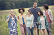 © Mint Images - A group of people, a man and five women, walking through the countryside.