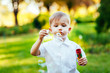 © davit85 - Little boy with soap bubbles in summer park.