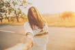 © kegfire - First person portrait of a smiling girl holding hand on sunset. Adorable young woman on sunny day