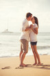 © EpicStockMedia - Young Couple Kissing on the Beach at Sunset