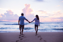 Lovers Walking On The Beach At Sunset On Vacation
