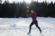 © .shock - yougn woman jogging outdoor on snow in forest