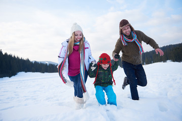 happy family playing together in snow at winter