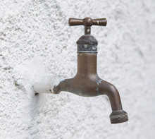 Old Water Tap On A White Wall