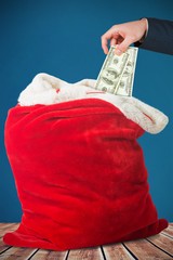 Poster - Composite image of hand holding hundred dollar bills
