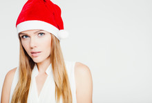Portrait Of Beautiful Young Woman Wearing Santa Claus Hat