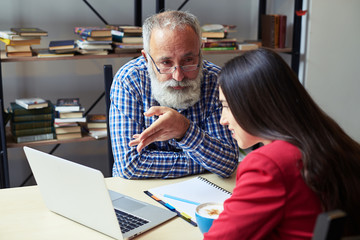 man explaining something to woman, looking at her