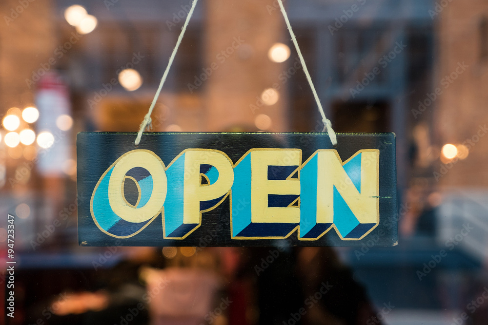 Open vintage wooden sign broad through the glass of store window - obrazy, fototapety, plakaty 