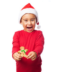 A little boy holding a ginger cookie