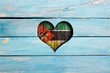 Love Mozambique. Heart and flag on a blue wooden board